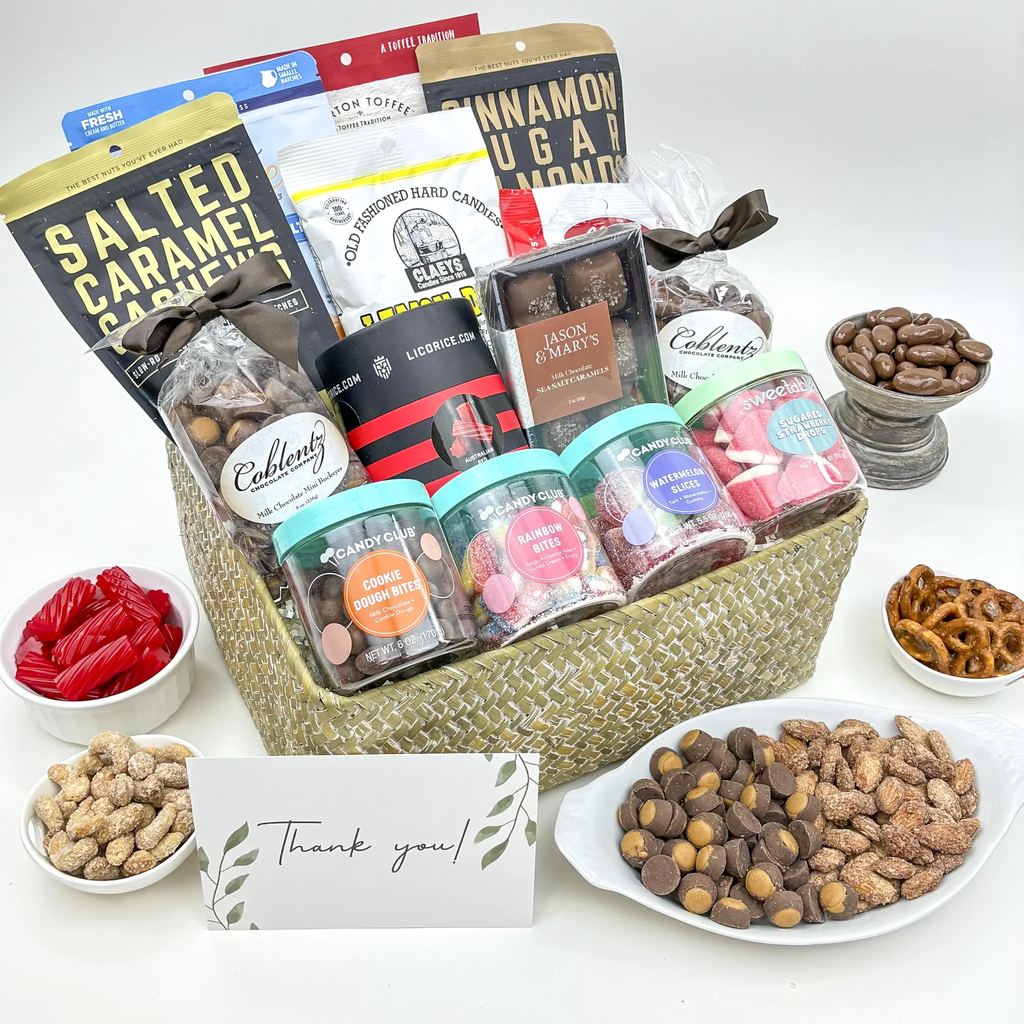 Assorted candy and toffee gift basket with bags of sweets, bowls of chocolates, and a thank-you card